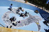 Workmen Put the Finishing Touches on Whale Shark Mosaic in the New Swimming Pool
